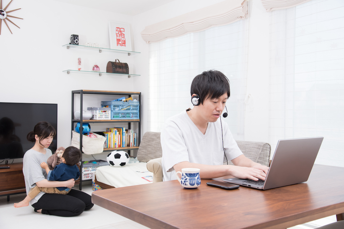 家族と同じ部屋でリモートweb会議をする父